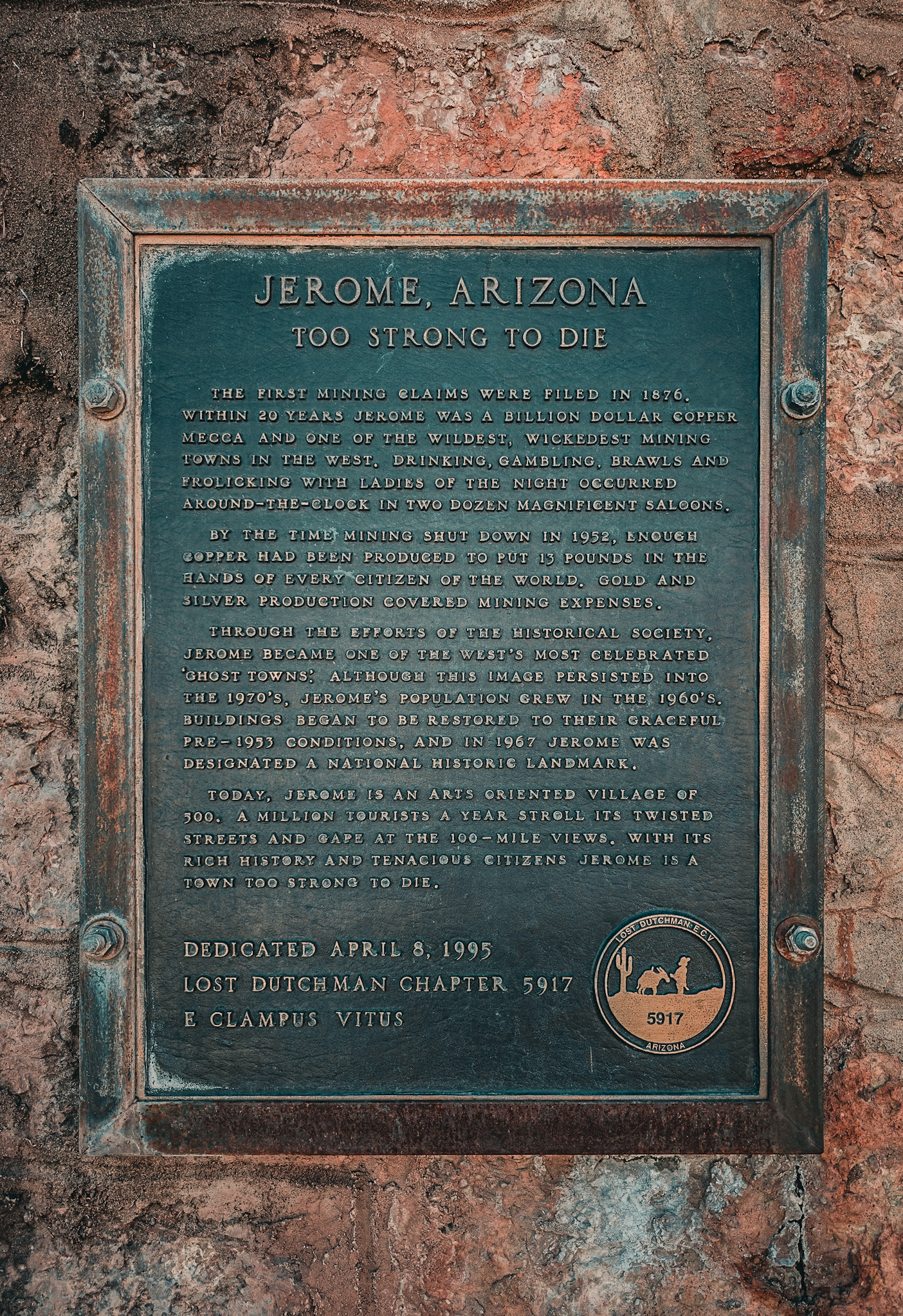 Jerome Arizona &mdash; Too Strong to Die &mdash; patinated bronze historical marker on the red rock wall