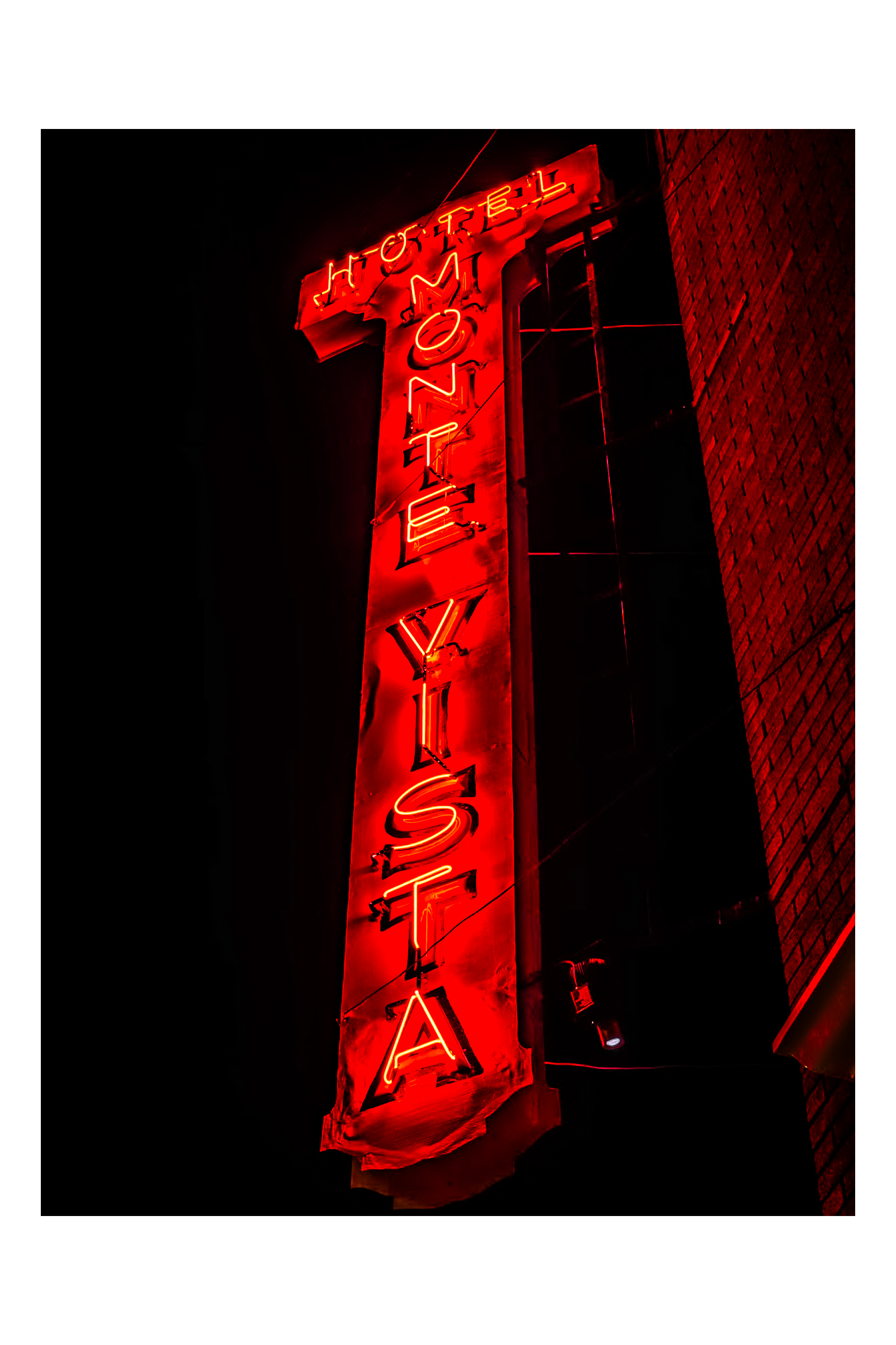Hotel Monte Vista neon sign blazing vermillion against the Flagstaff night sky