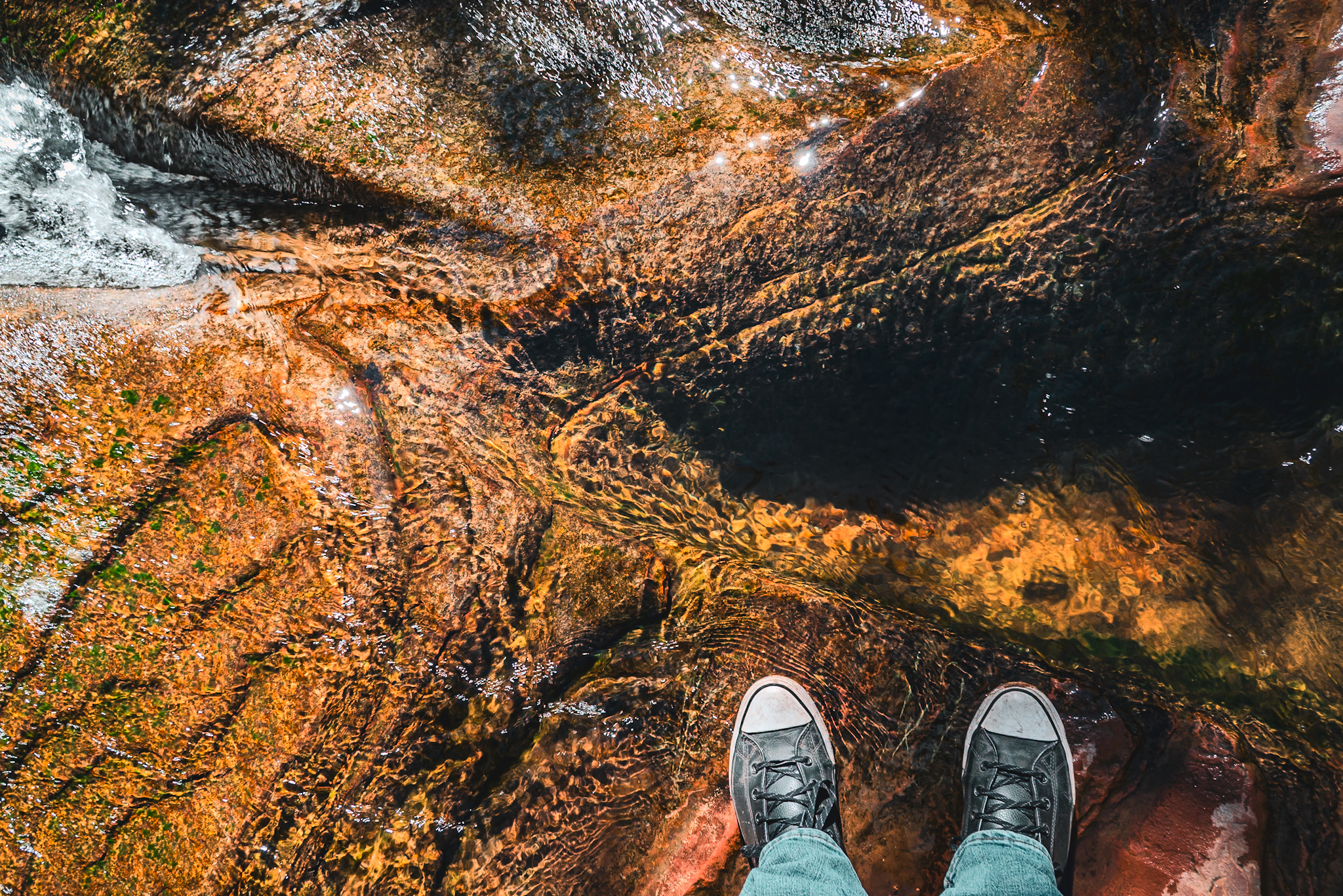 Standing in Oak Creek, Sedona Arizona &mdash; crystal water flowing over glowing red sandstone