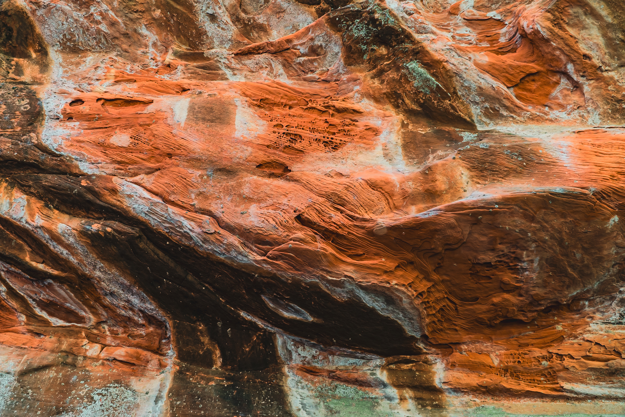 Iron oxide layers in Sedona sandstone &mdash; geological time rendered in flowing red and amber