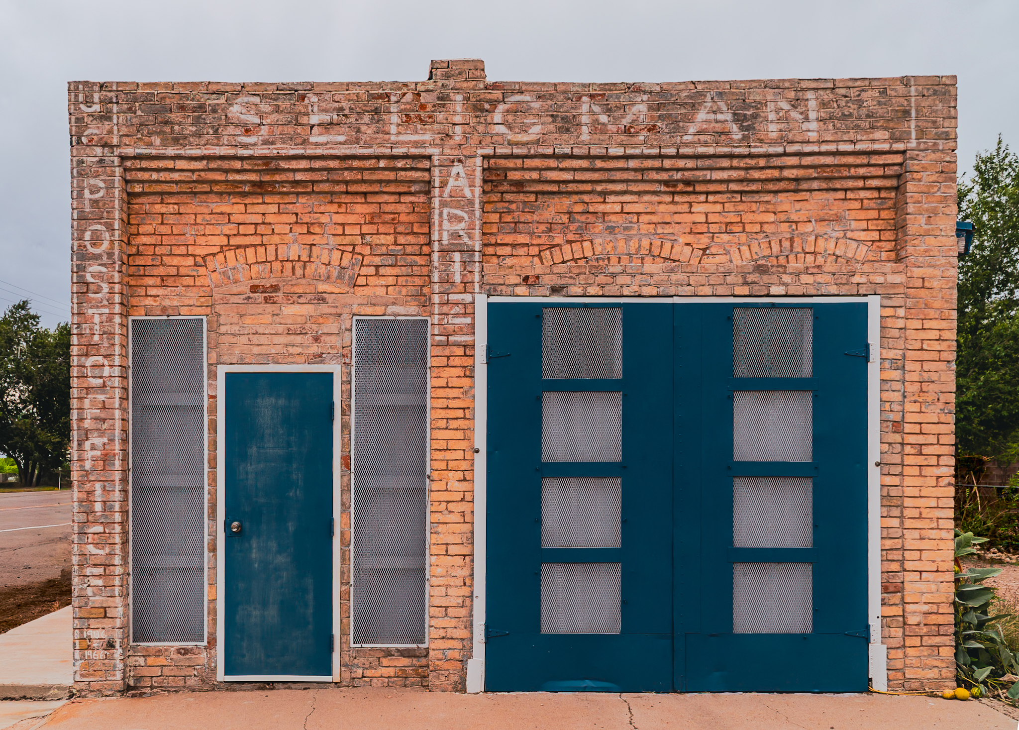 Seligman Arizona post office &mdash; brick facade with teal doors, the heart of the old Route 66 town