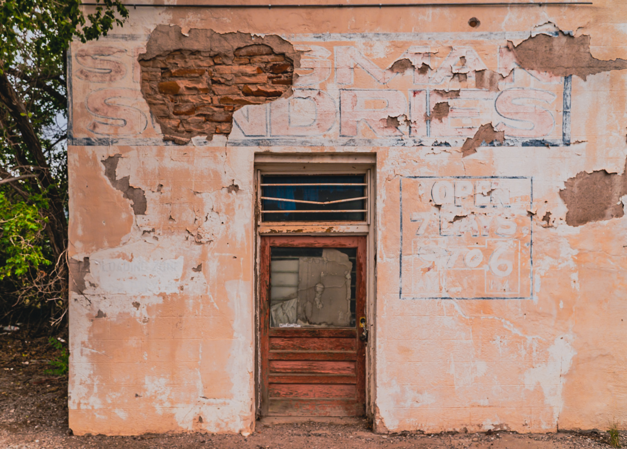 Abandoned Sundries store, Seligman Arizona &mdash; ghost signage through peeling stucco, Route 66