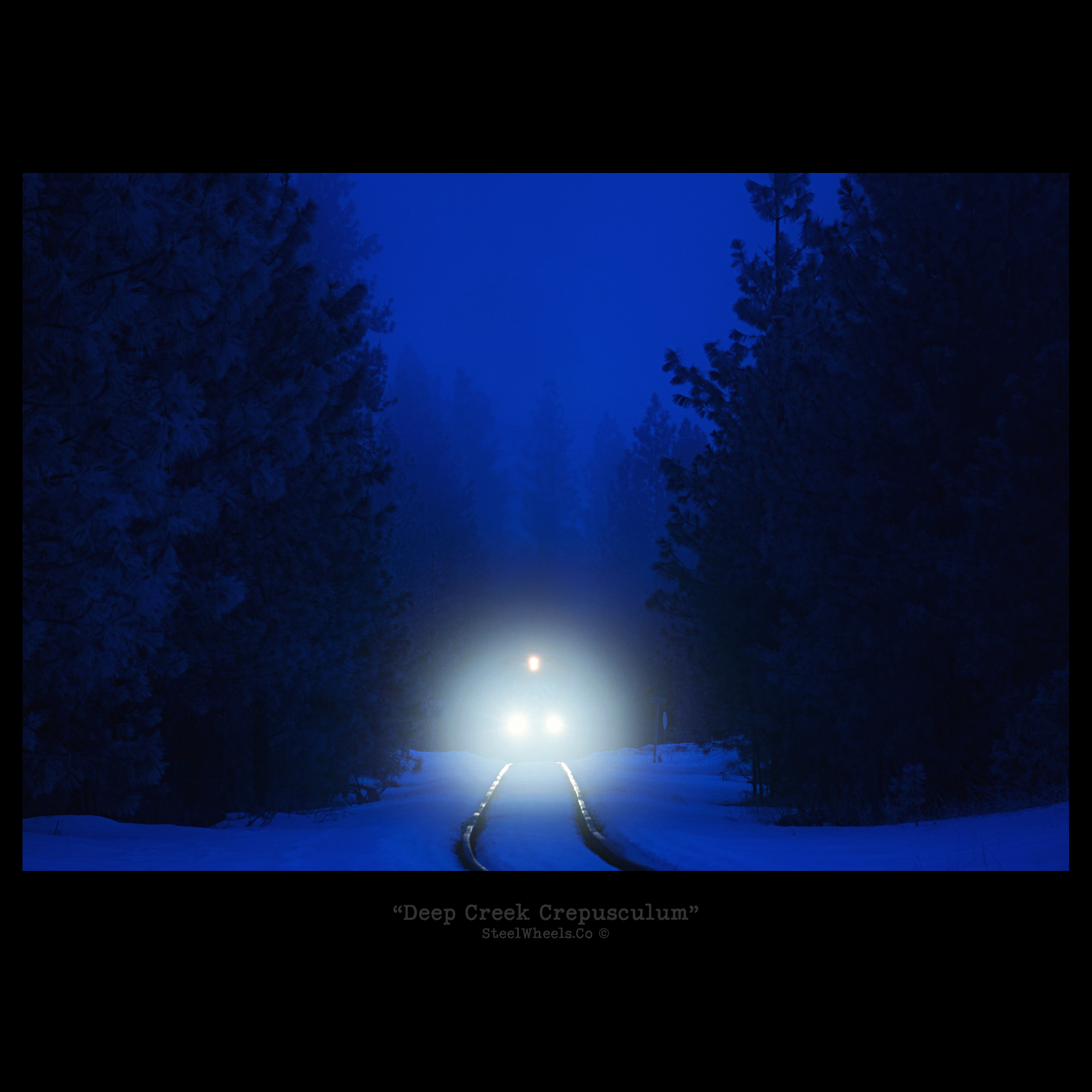 Locomotive headlights in the blue dark of a winter forest